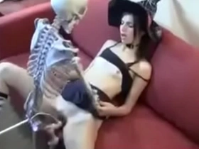 Skull-themed decorations enhance the sexual encounter between a woman and her lover on Halloween