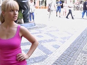A seductive woman bares her breasts in the heart of a bustling public space