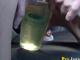 Japanese beauty fills her cup with urine in erotic pee fetish video